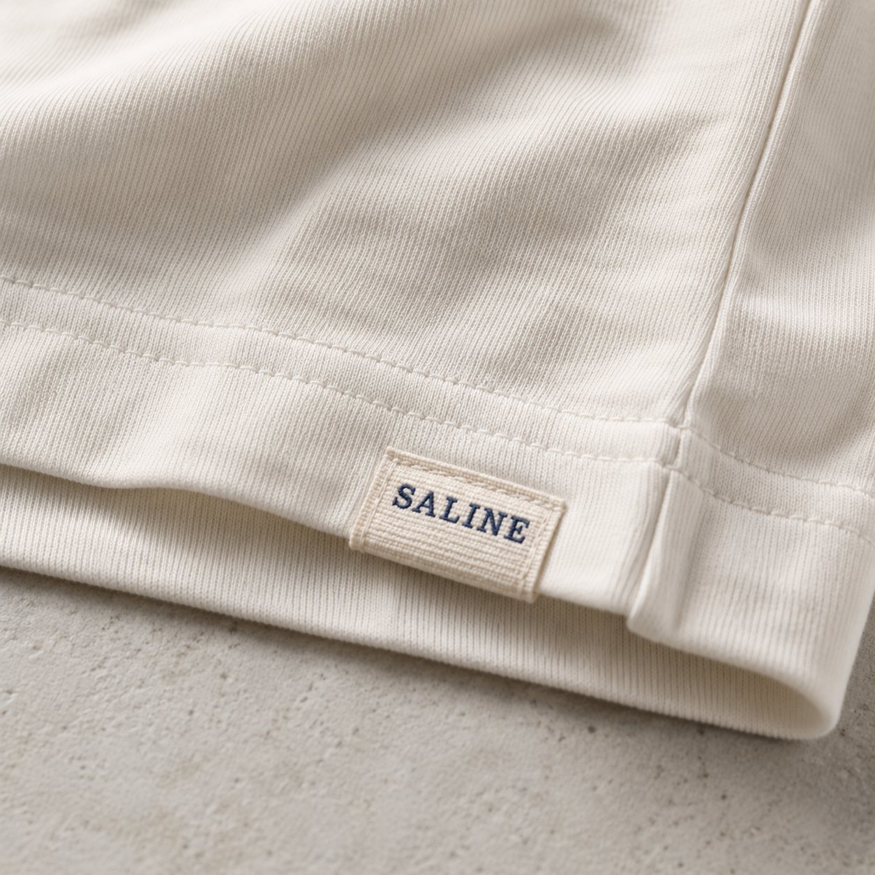 Woven SALINE hem label on the side seam