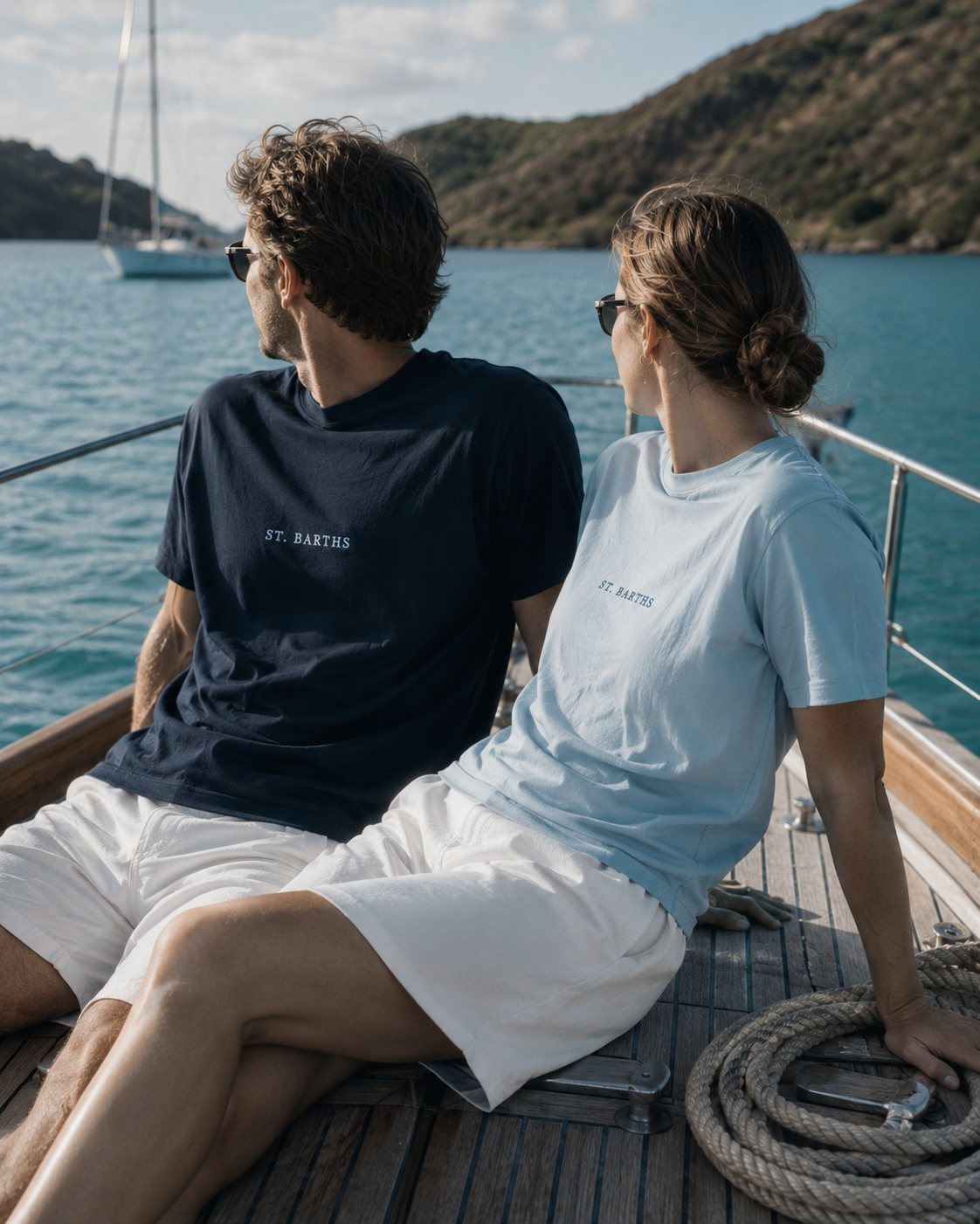 At anchor — couple in tees on a sloop